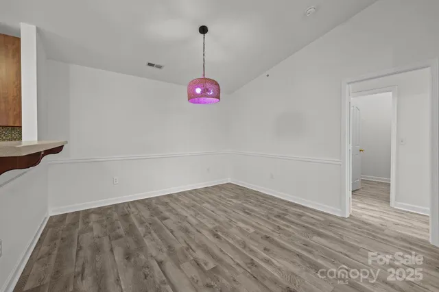 a view of a room with wooden floor and window