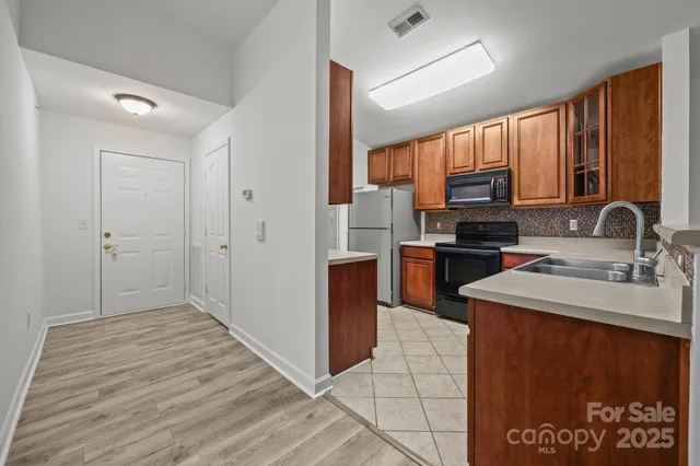 a kitchen with stainless steel appliances a sink stove and refrigerator