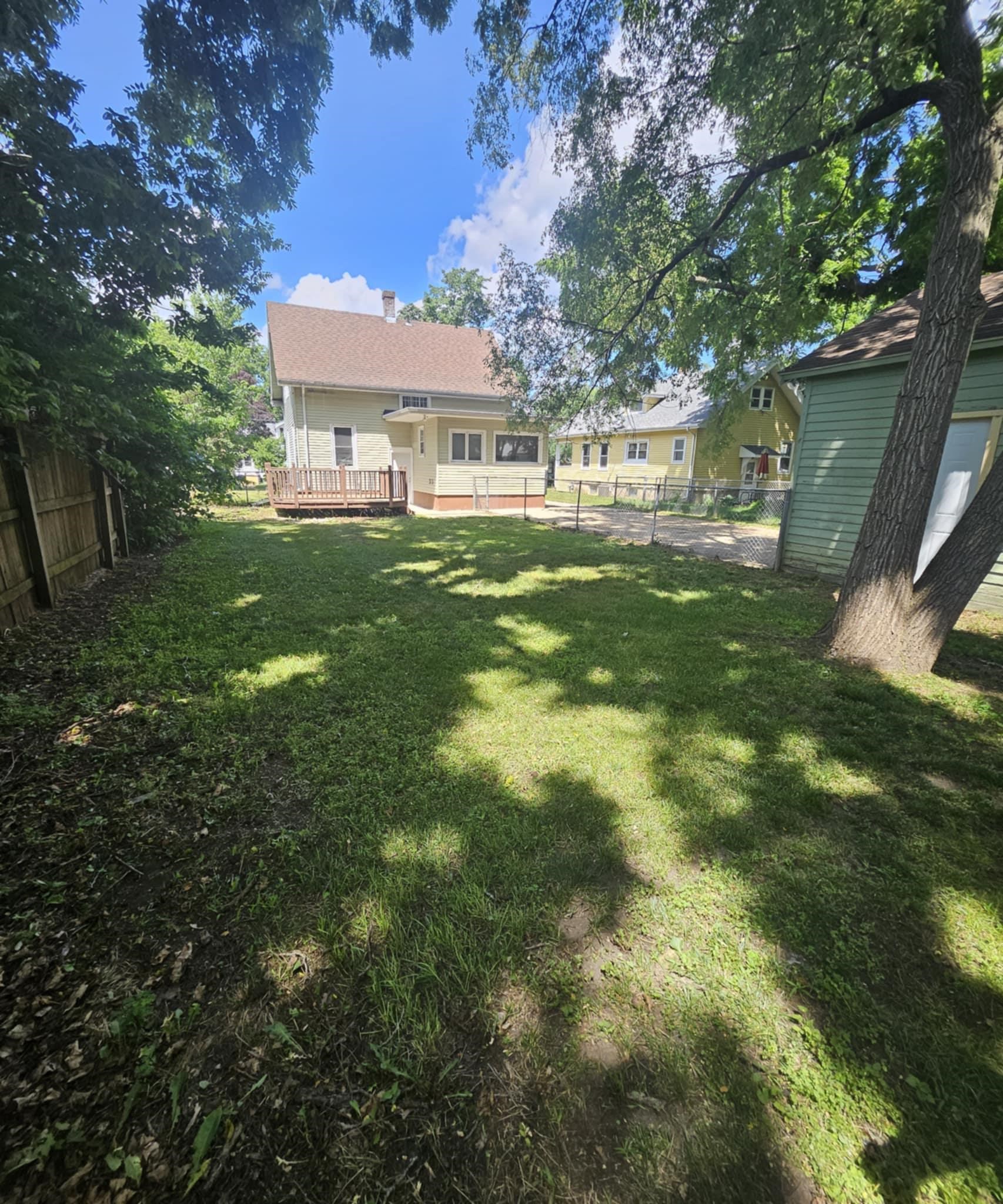 1219 Hackett Street Beloit, WI 53511 - Photo 18 of 19 a view of a big yard next to a house