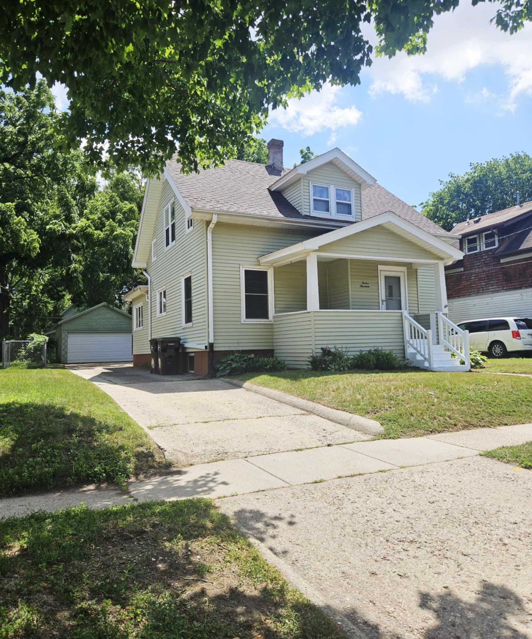 1219 Hackett Street Beloit, WI 53511 - Photo 2 of 19 a front view of a house with a yard and garage