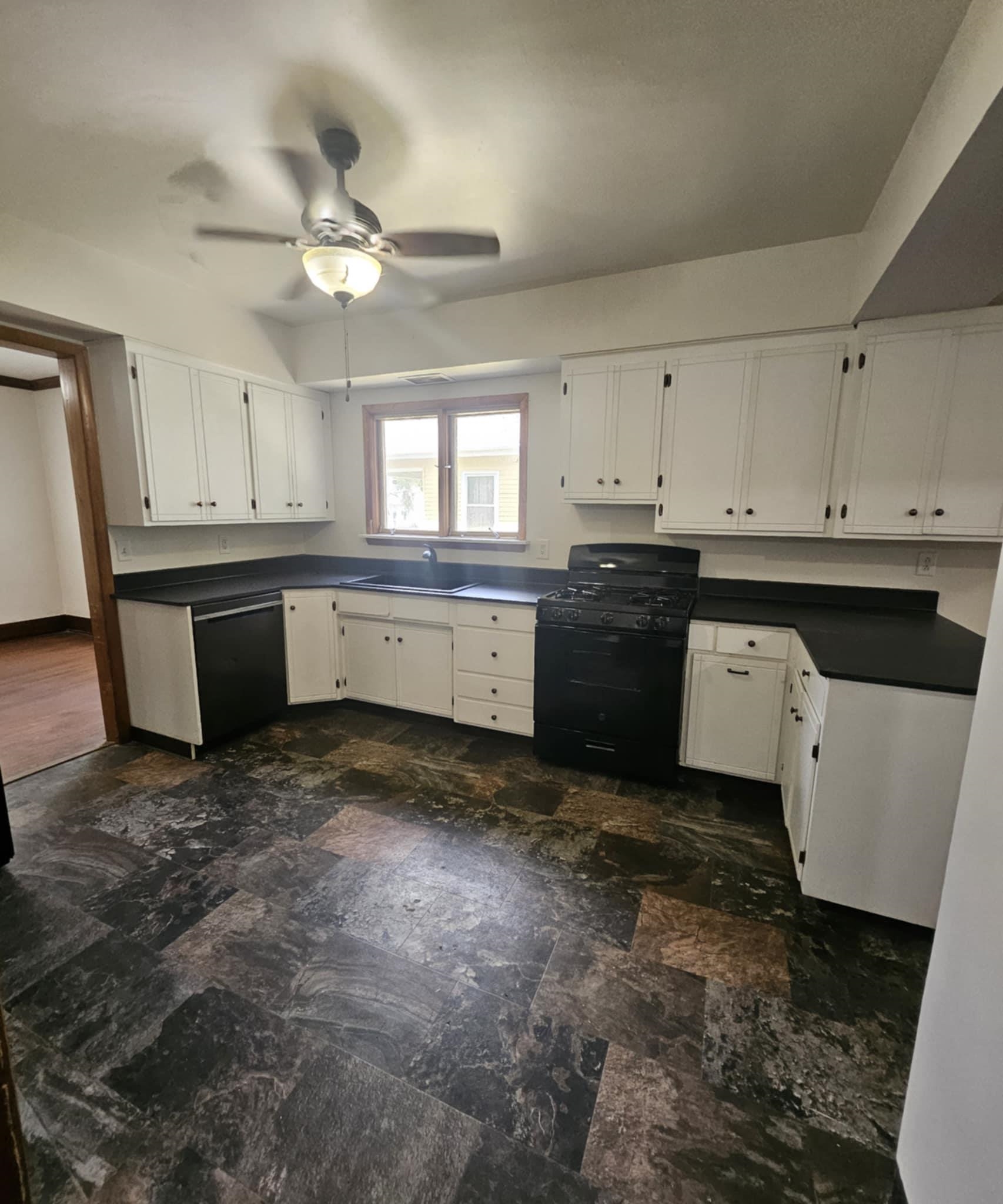 1219 Hackett Street Beloit, WI 53511 - Photo 5 of 19 a large kitchen with cabinets and wooden floor