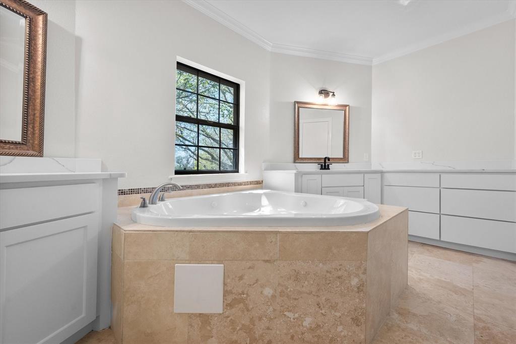 1105 East Highland Road Oak Leaf, TX 75154 - Photo 27 of 40 a bathroom with a tub sink and mirror