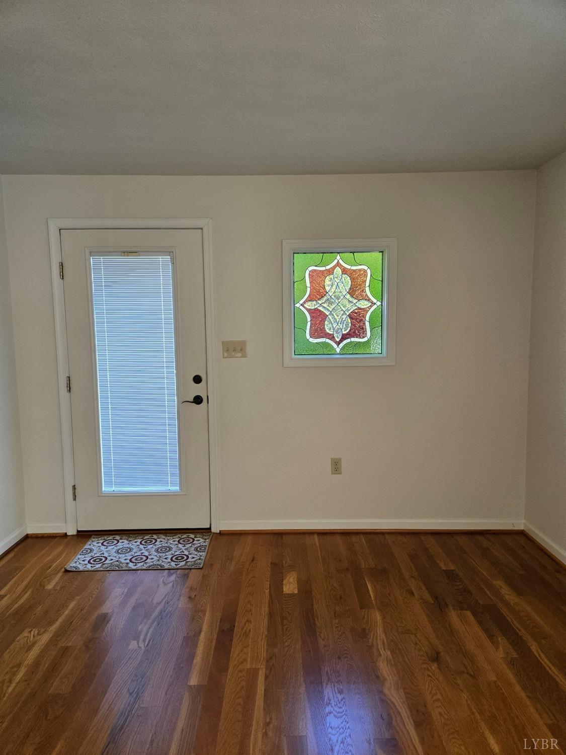 8968 Red House Road Appomattox, VA 24522 - Photo 10 of 31 an empty room with wooden floor and windows