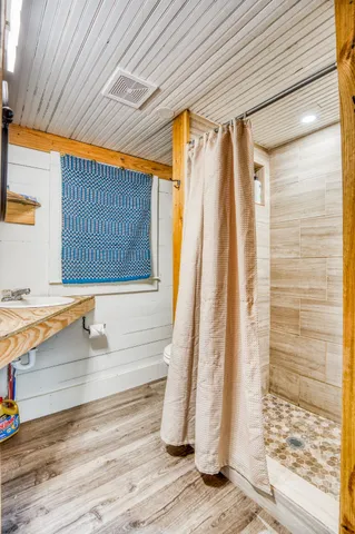 a view of a room with wooden floor and a sink