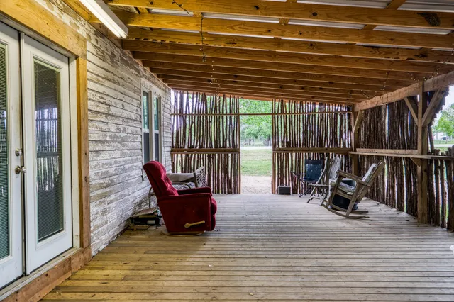 a view of a patio with a table and chairs and wooden floor