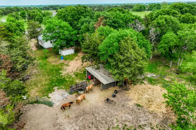 an aerial view of a house with a yard