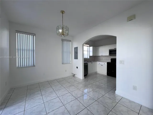 a view of a kitchen with a sink and a stove top oven