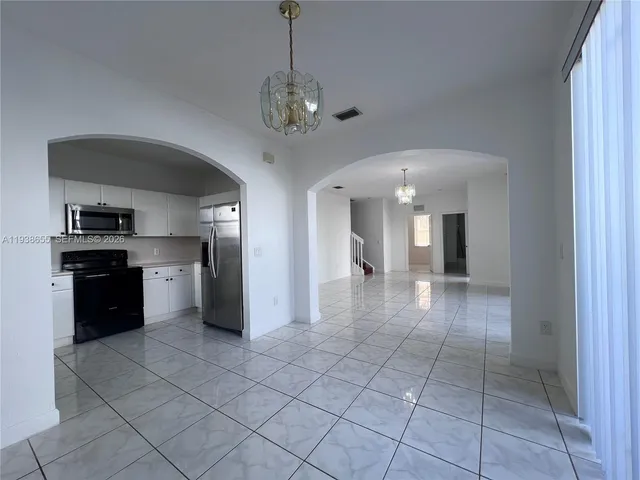 a kitchen with a refrigerator stove and sink