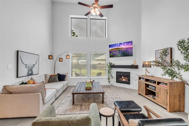 a living room with furniture fireplace and flat screen tv