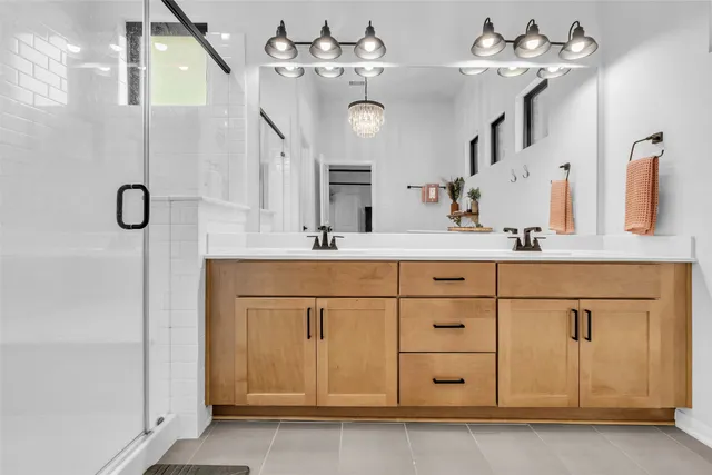 a bathroom with a sink vanity and a mirror