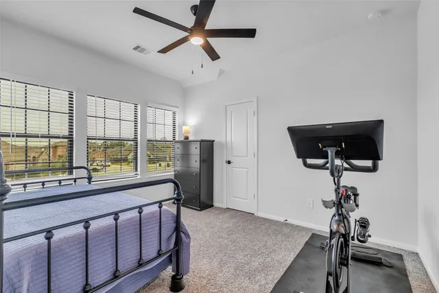 a view of a livingroom with furniture window and a ceiling fan