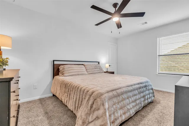 a bedroom with a bed and window