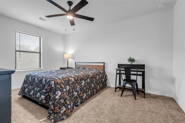 a bedroom with bed and a window