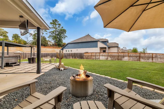 a view of a patio with a table chairs and a yard
