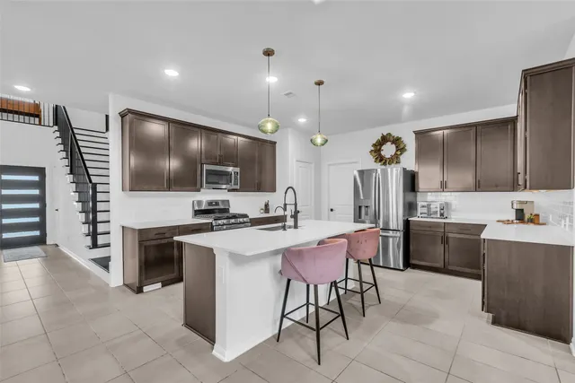 a large kitchen with a table and chairs