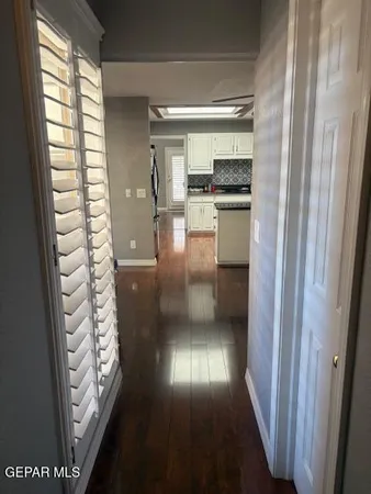 a view of entryway and hall with wooden floor