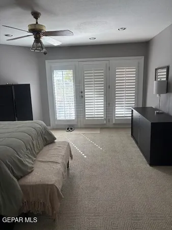 a spacious bathroom with a mirror and a sink