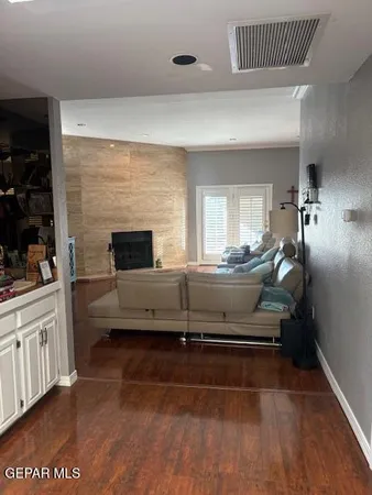 a living room with a balcony furniture and a fireplace