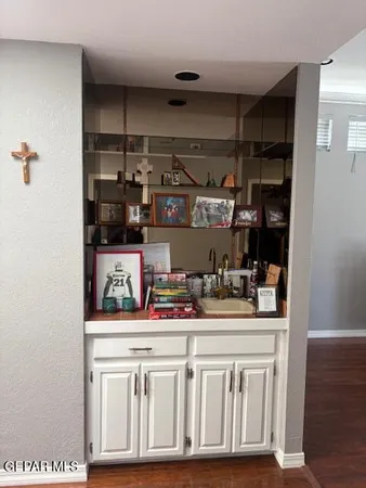 a kitchen with white cabinets and appliances