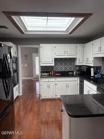 a kitchen with granite countertop a stove a sink and a granite counter tops