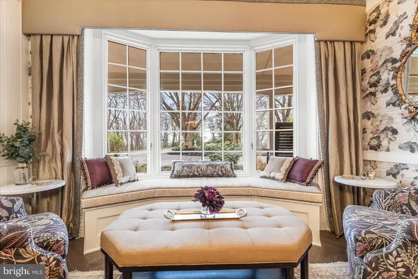 a living room with furniture a fireplace and a large window