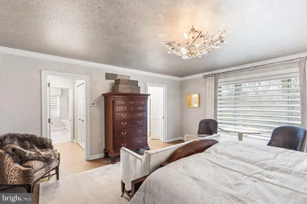 a kitchen with stainless steel appliances a refrigerator stove and white cabinets
