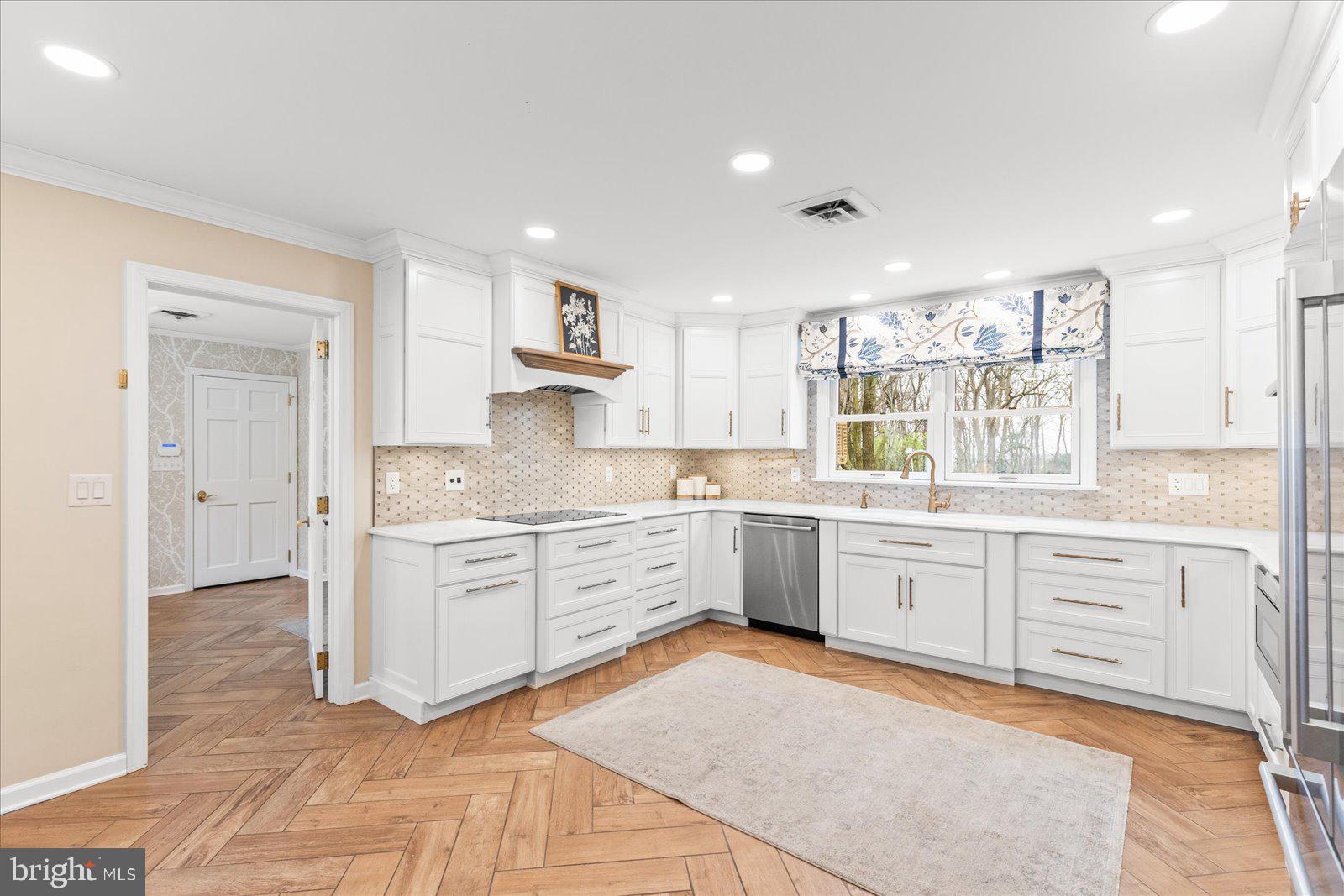 6759 Moulstown Road Hanover, PA 17331 - Photo 41 of 111 a large white kitchen with granite countertop a sink white cabinets and white appliances