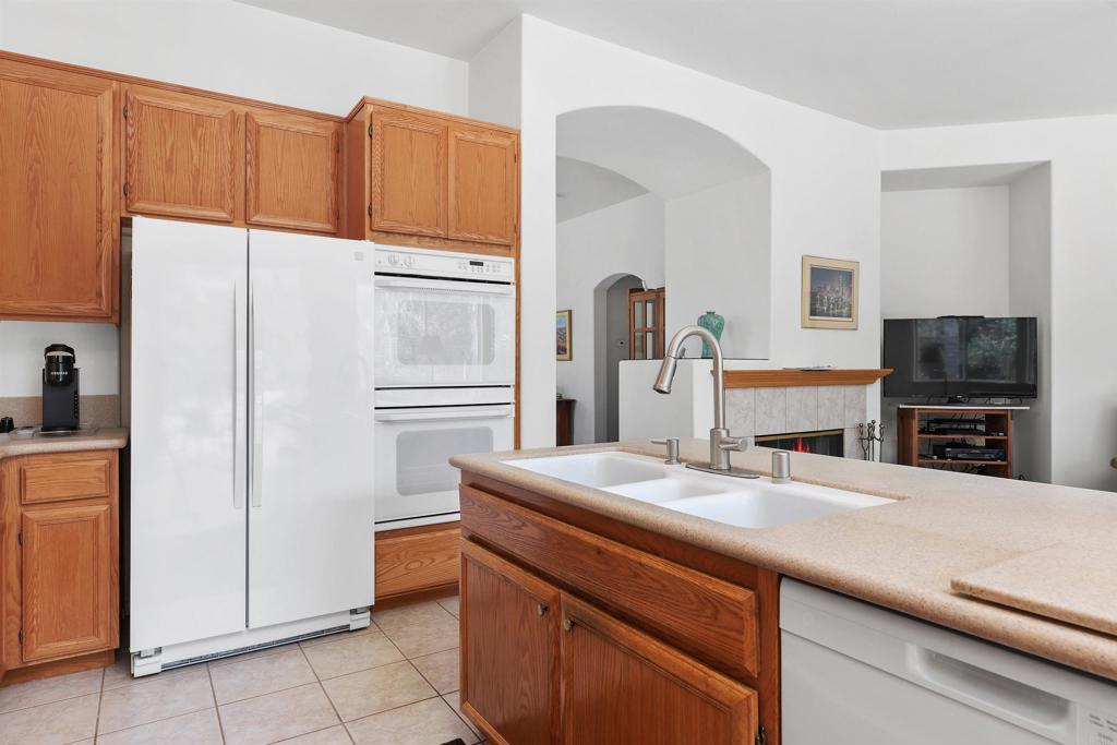 2330 Longfellow Road Carlsbad, CA 92008 - Photo 14 of 30 a kitchen with kitchen island a counter appliances a sink and cabinets