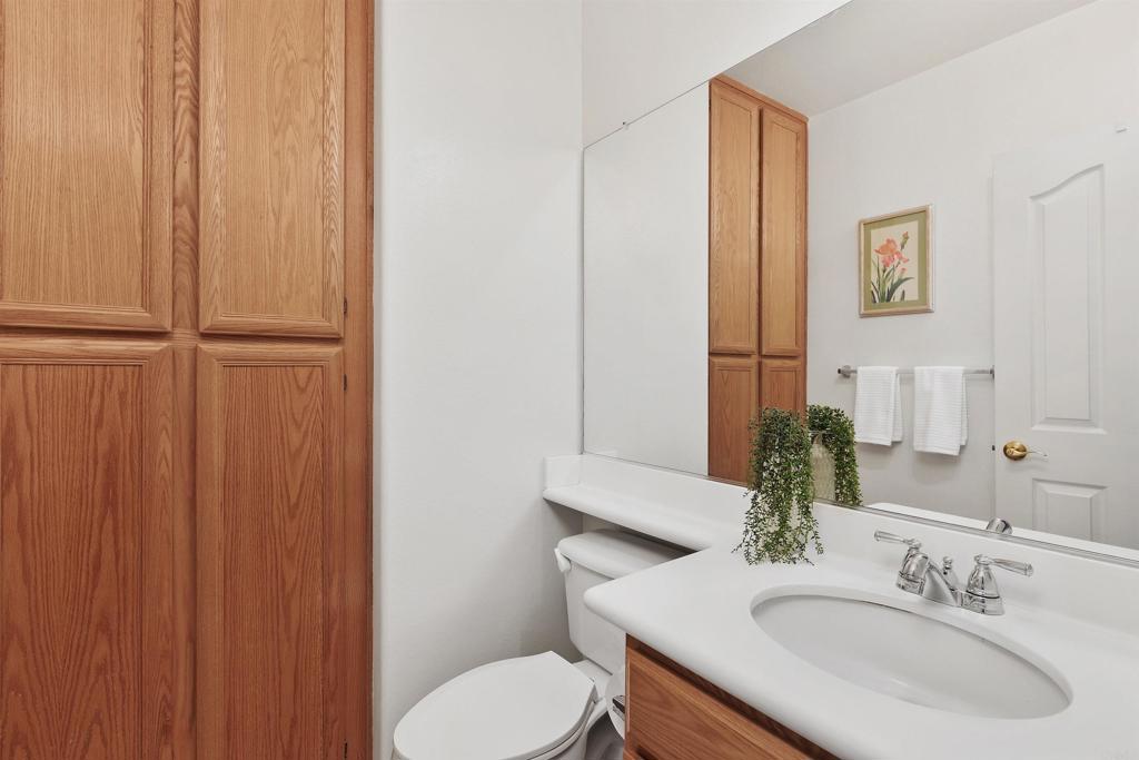 2330 Longfellow Road Carlsbad, CA 92008 - Photo 16 of 30 a bathroom with a sink toilet and mirror