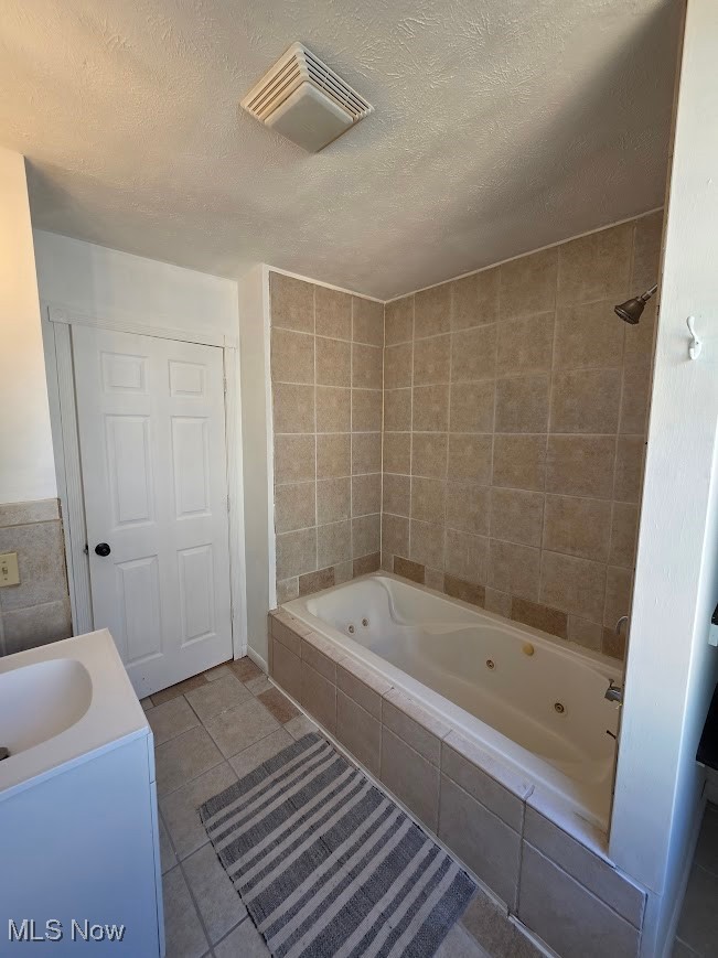 1445 Hubbard Road Madison, OH 44057 - Photo 14 of 21 Bathroom featuring tile walls, light tile patterned flooring, a textured ceiling, and vanity