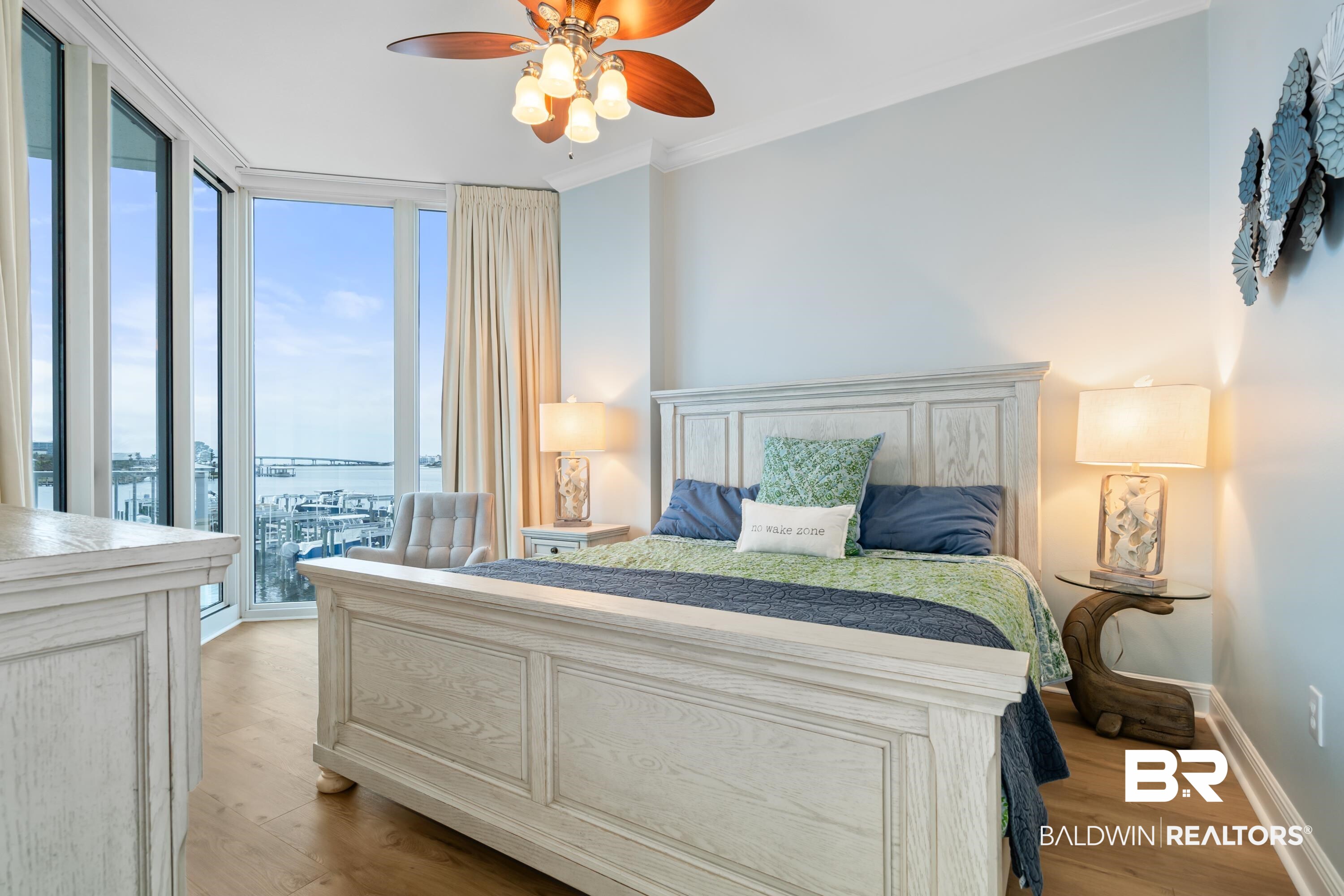 28250 Canal Road, Unit 101 Orange Beach, AL 36561 - Photo 10 of 34 Bedroom featuring light wood-style flooring, crown molding, floor to ceiling windows, and baseboards