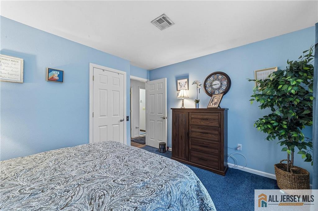 491A Delair Road, Unit 491B Monroe Township, NJ 08831 - Photo 13 of 22 a bedroom with a bed and a potted plant