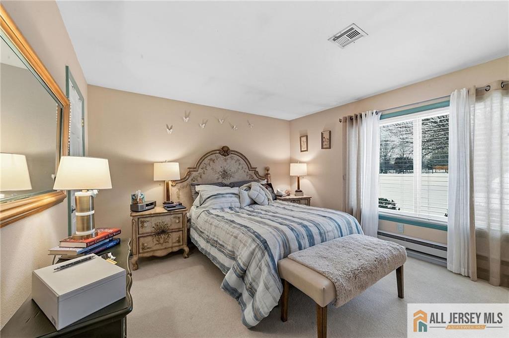 491A Delair Road, Unit 491B Monroe Township, NJ 08831 - Photo 15 of 22 a bedroom with a bed and a lamp