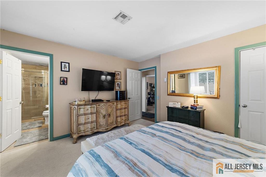 491A Delair Road, Unit 491B Monroe Township, NJ 08831 - Photo 16 of 22 a bedroom with a bed and a flat screen tv