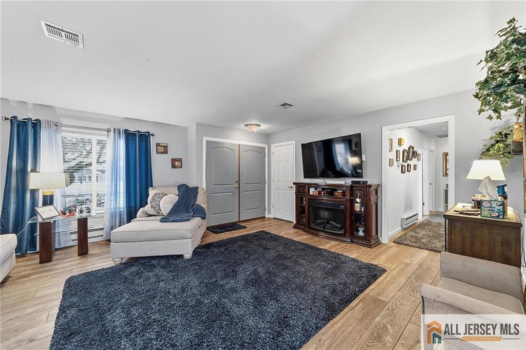 491A Delair Road, Unit 491B Monroe Township, NJ 08831 - Photo 3 of 22 a living room with furniture and a flat screen tv