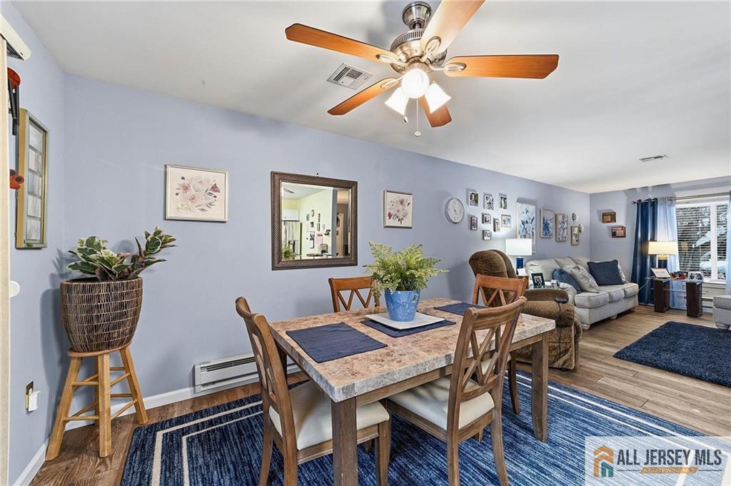 491A Delair Road, Unit 491B Monroe Township, NJ 08831 - Photo 10 of 22 a dining room with furniture a rug and wooden floor