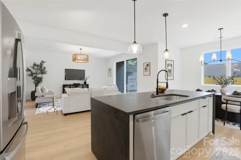 a kitchen with sink stove and refrigerator