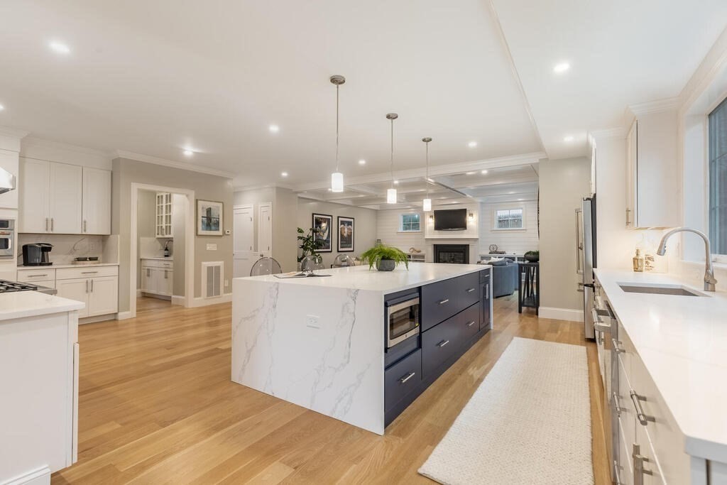 1019 Central Avenue Needham, MA 02492 - Photo 13 of 28 a large kitchen with stainless steel appliances kitchen island a large counter top and a view of living room