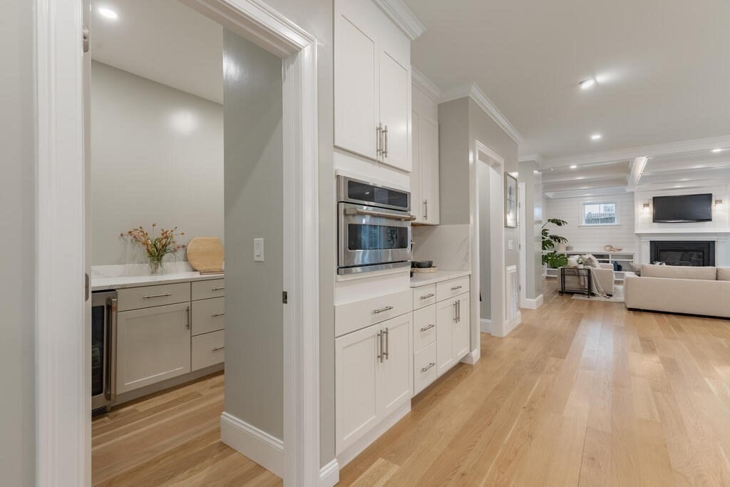 1019 Central Avenue Needham, MA 02492 - Photo 14 of 28 a kitchen with granite countertop cabinets appliances and wooden floor