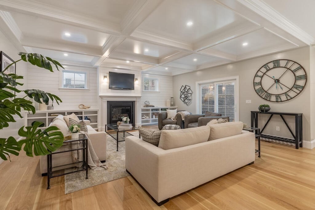 1019 Central Avenue Needham, MA 02492 - Photo 17 of 28 a living room with furniture a fireplace and a flat screen tv