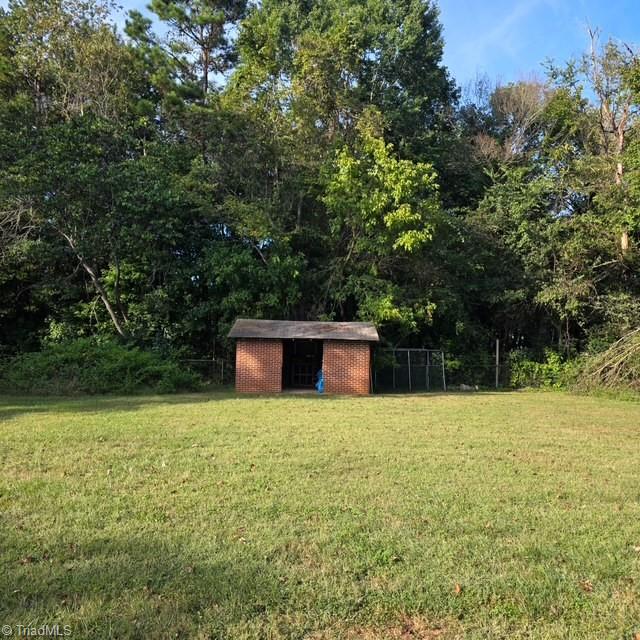 Backyard with a small brick storage building
