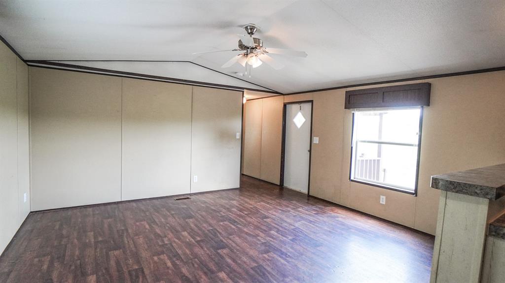 1104 North King Road Fate, TX 75189 - Photo 5 of 15 a view of an empty room with a window and wooden floor