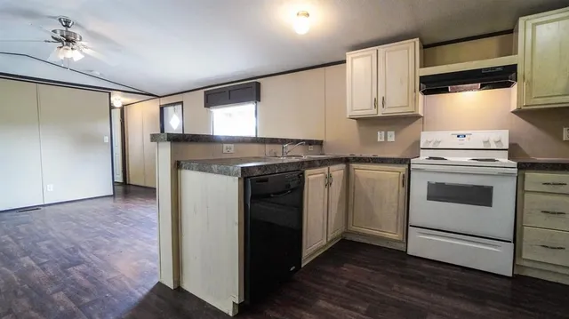 a kitchen with a stove oven and sink