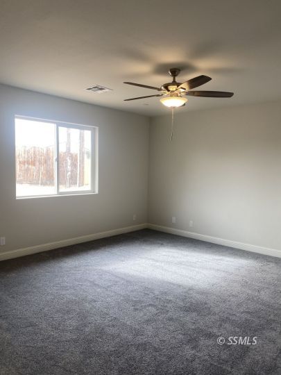 1405 Porter Street Ridgecrest, CA 93555 - Photo 16 of 23 an empty room with windows and fan