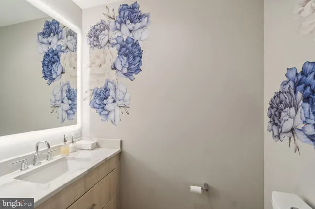 a bathroom with a sink vanity and a mirror