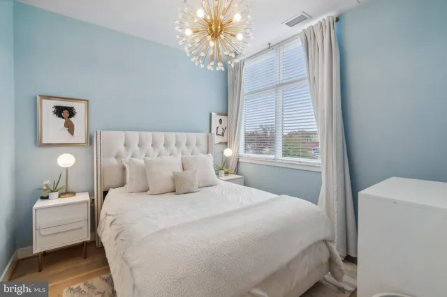 a bedroom with a large bed and a window