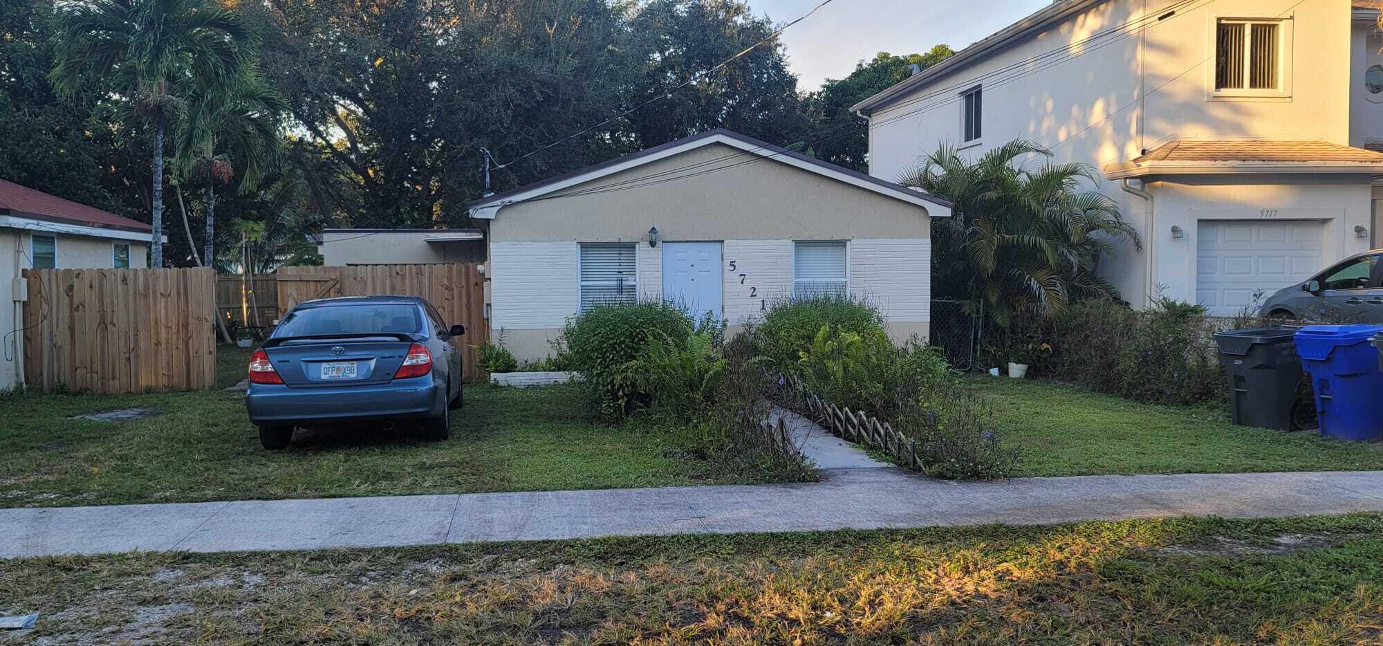 5721 Fillmore Street Hollywood, FL 33021 - Photo 3 of 17 a front view of a house with a yard