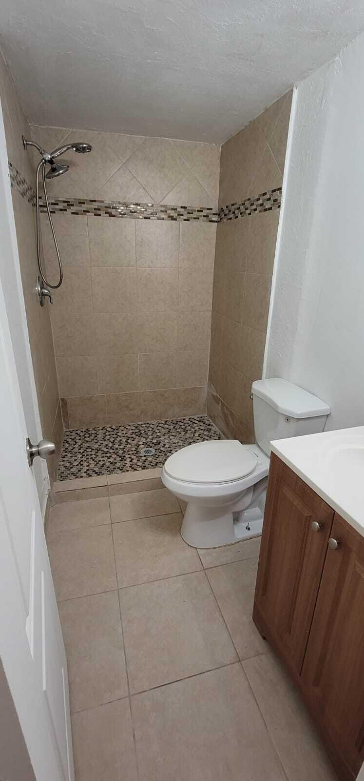 5721 Fillmore Street Hollywood, FL 33021 - Photo 8 of 17 a bathroom with a toilet and a shower