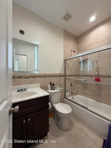 a spacious bedroom with a bed and a view of bathroom