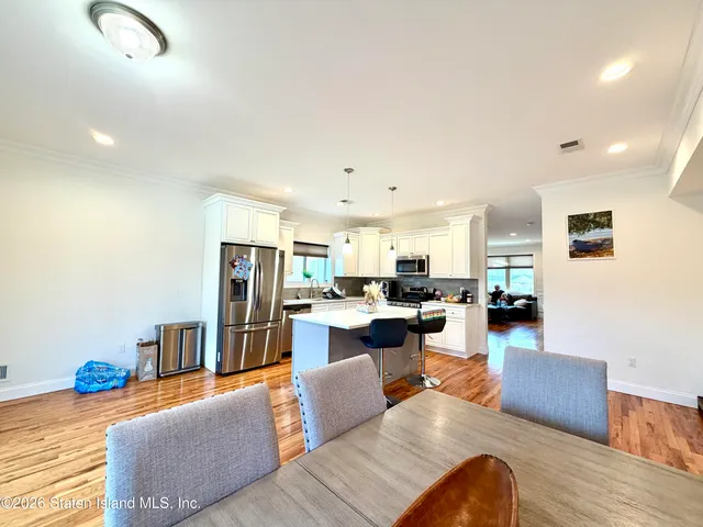 a living room with furniture and a view of kitchen